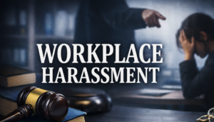 Woman sits at desk looking concerned while a colleague confronts her in an aggressive manner, illustrating workplace harassment in California